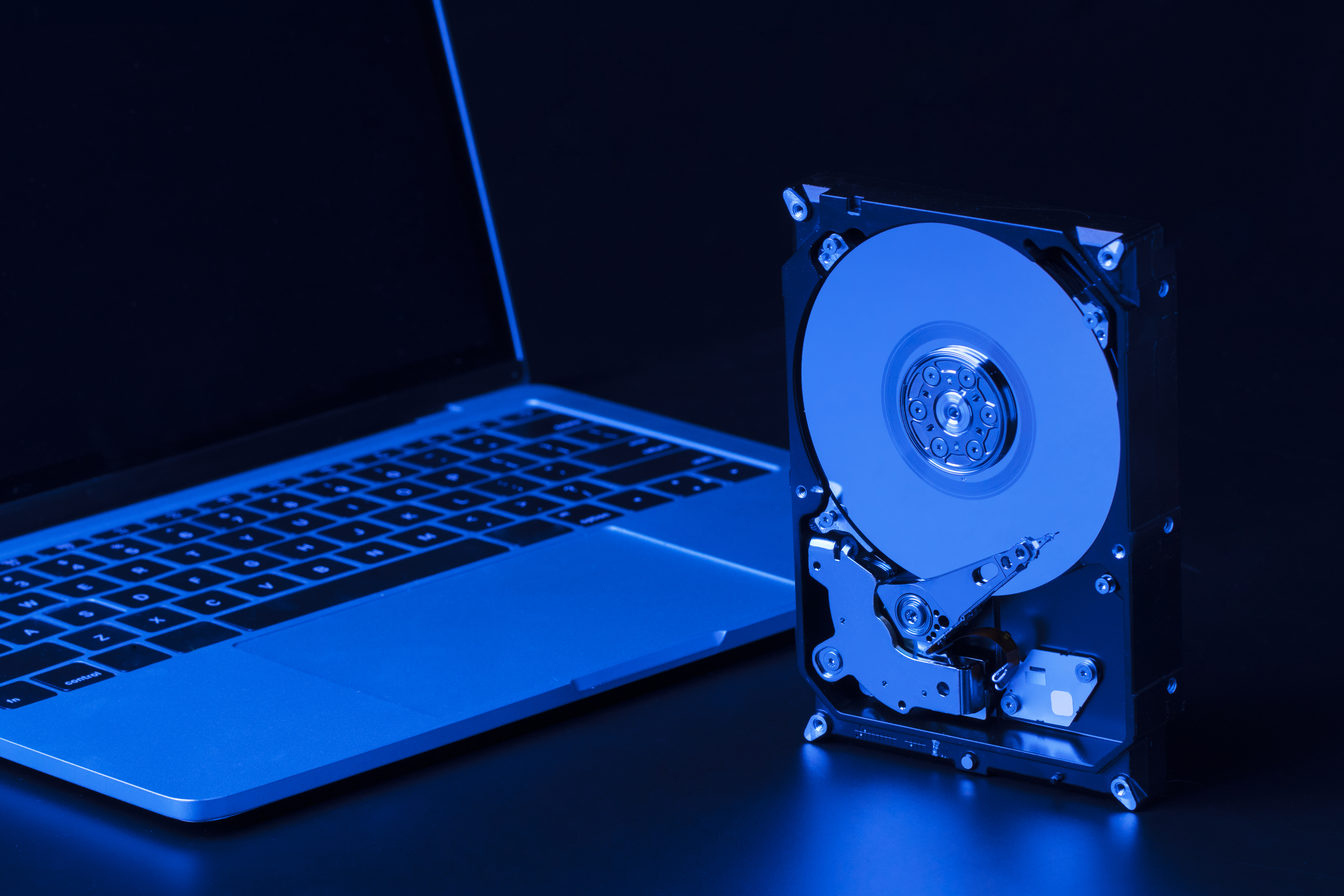 hard drive with blue light laptop high angle